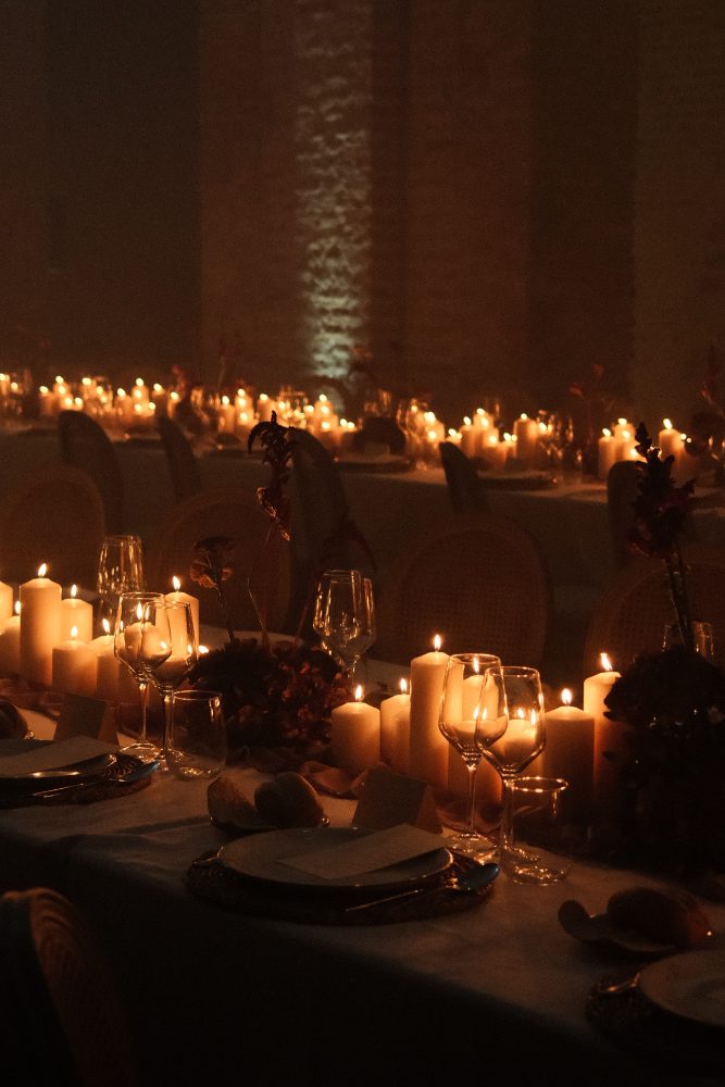 Mesa del banquete a la luz de las velas, con copas, platos y minutas, en el Convento de la Luz, Huelva
